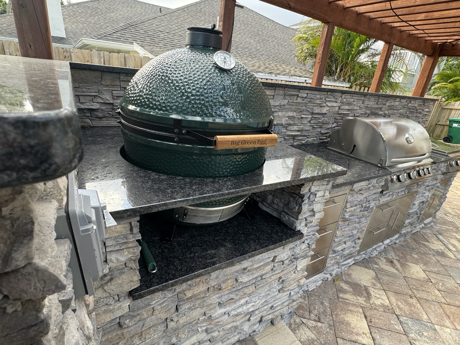Built-in Big Green Egg integrated into a custom outdoor kitchen by Endless Summer