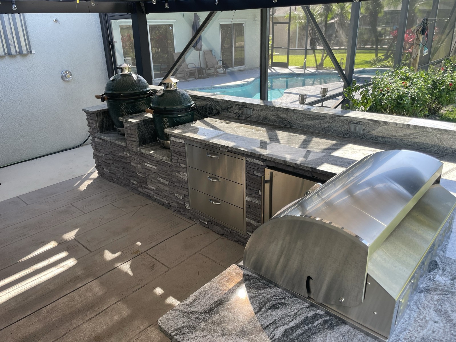 Large custom outdoor kitchen island with premium granite countertops built by Endless Summer in Brevard County, FL