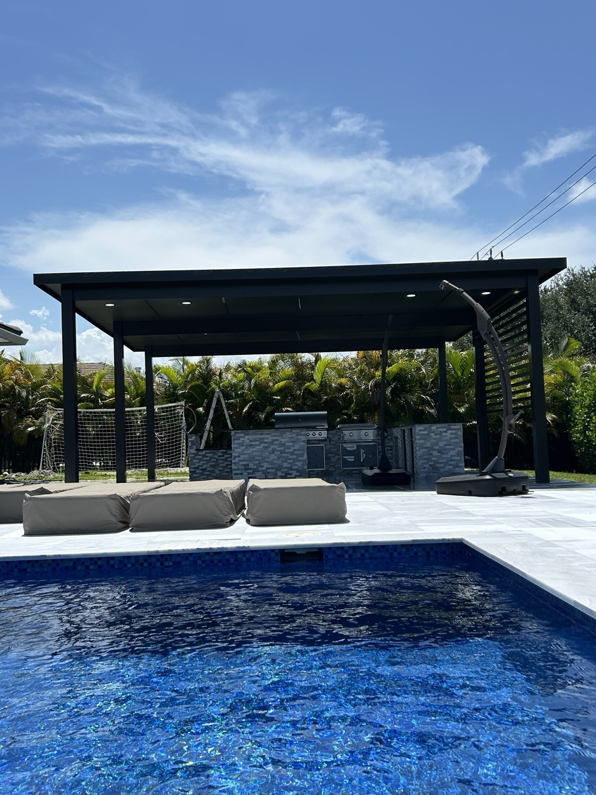 Modern pergola over a poolside outdoor kitchen in Melbourne, FL