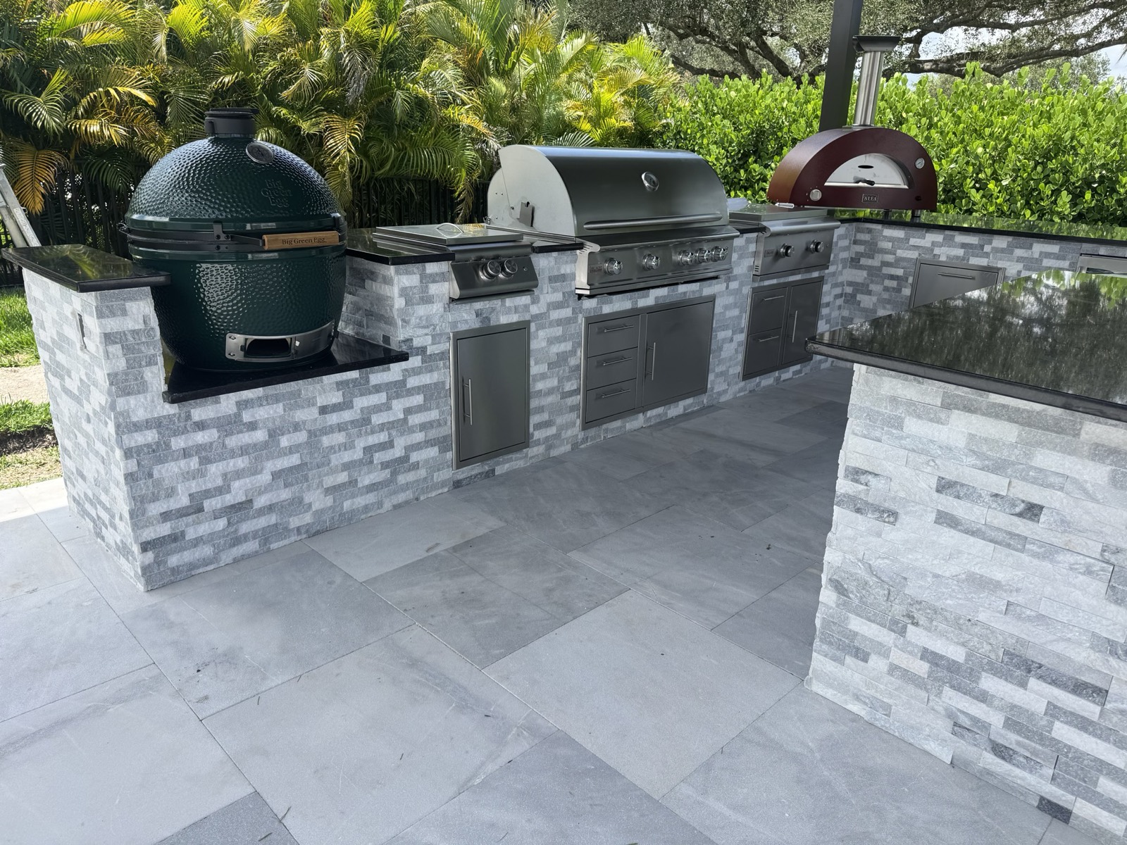 Stacked stone outdoor kitchen on a custom paver patio in the Space Coast, FL