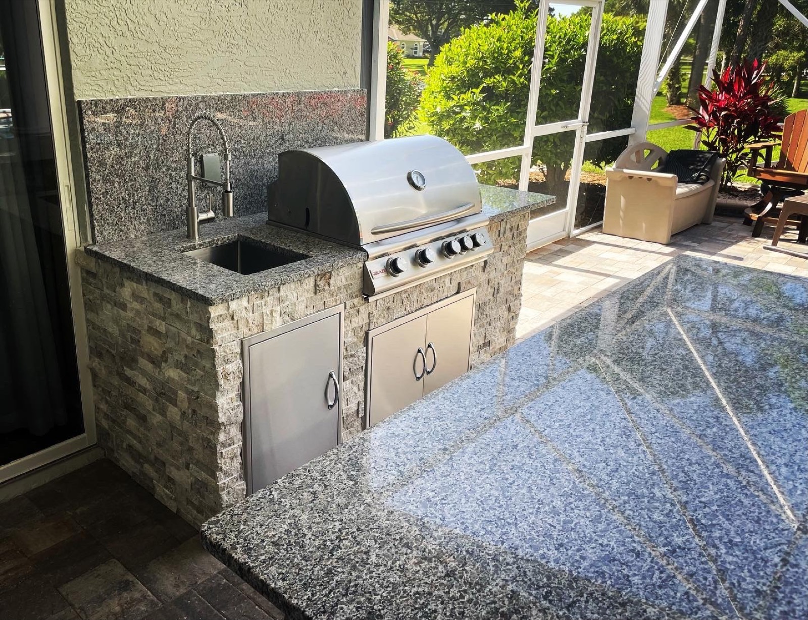 Poolside grill island with LED lighting at dusk in the Space Coast, FL