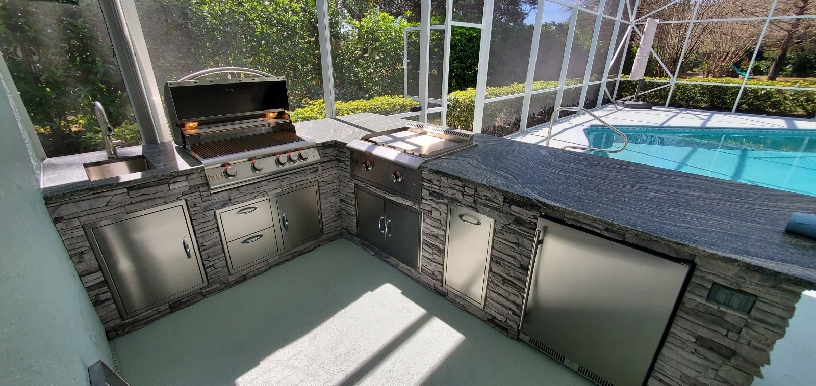 Poolside outdoor kitchen with water view in Brevard County, FL