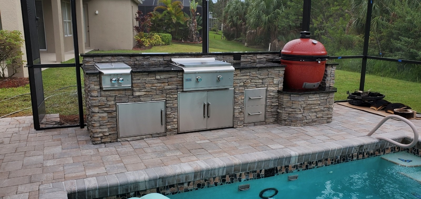 Stacked stone grill island with built-in grill detail by Endless Summer Outdoor Kitchens