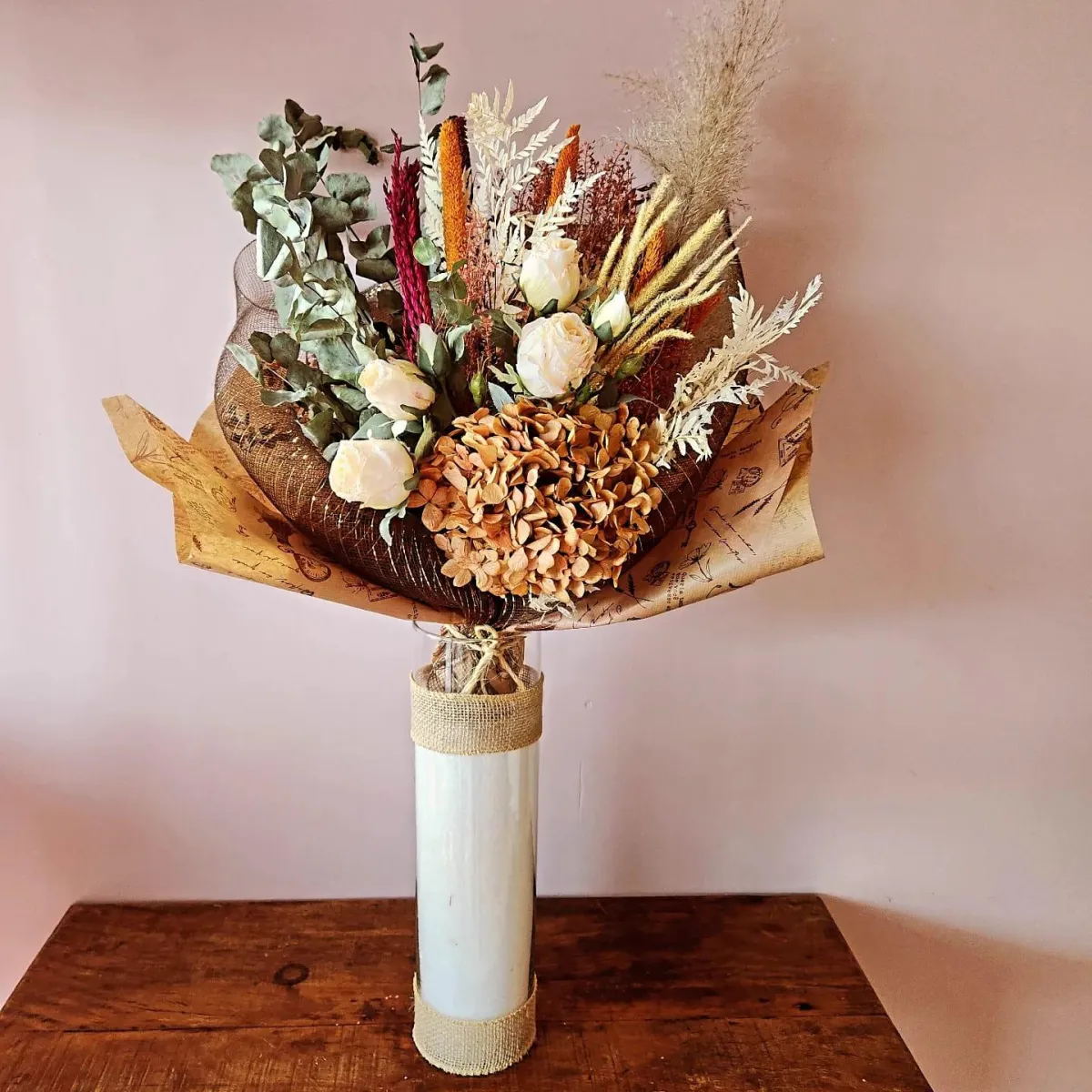 a picnic table with a basket and flowers
