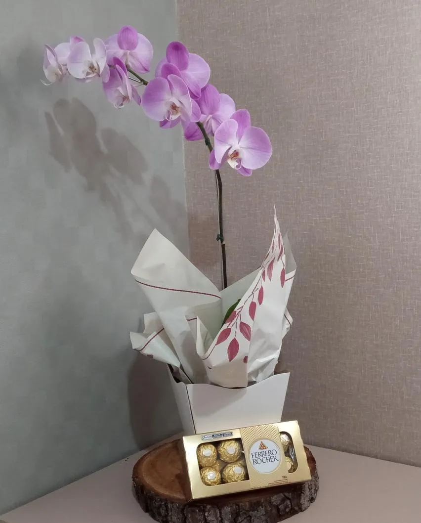 a picnic table with a basket and flowers