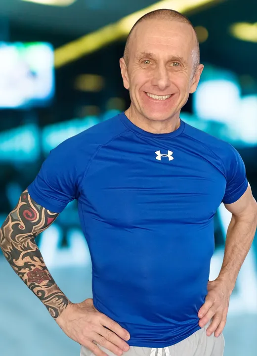 Tom Sawyer Fitness Trainer smiling in workout gear