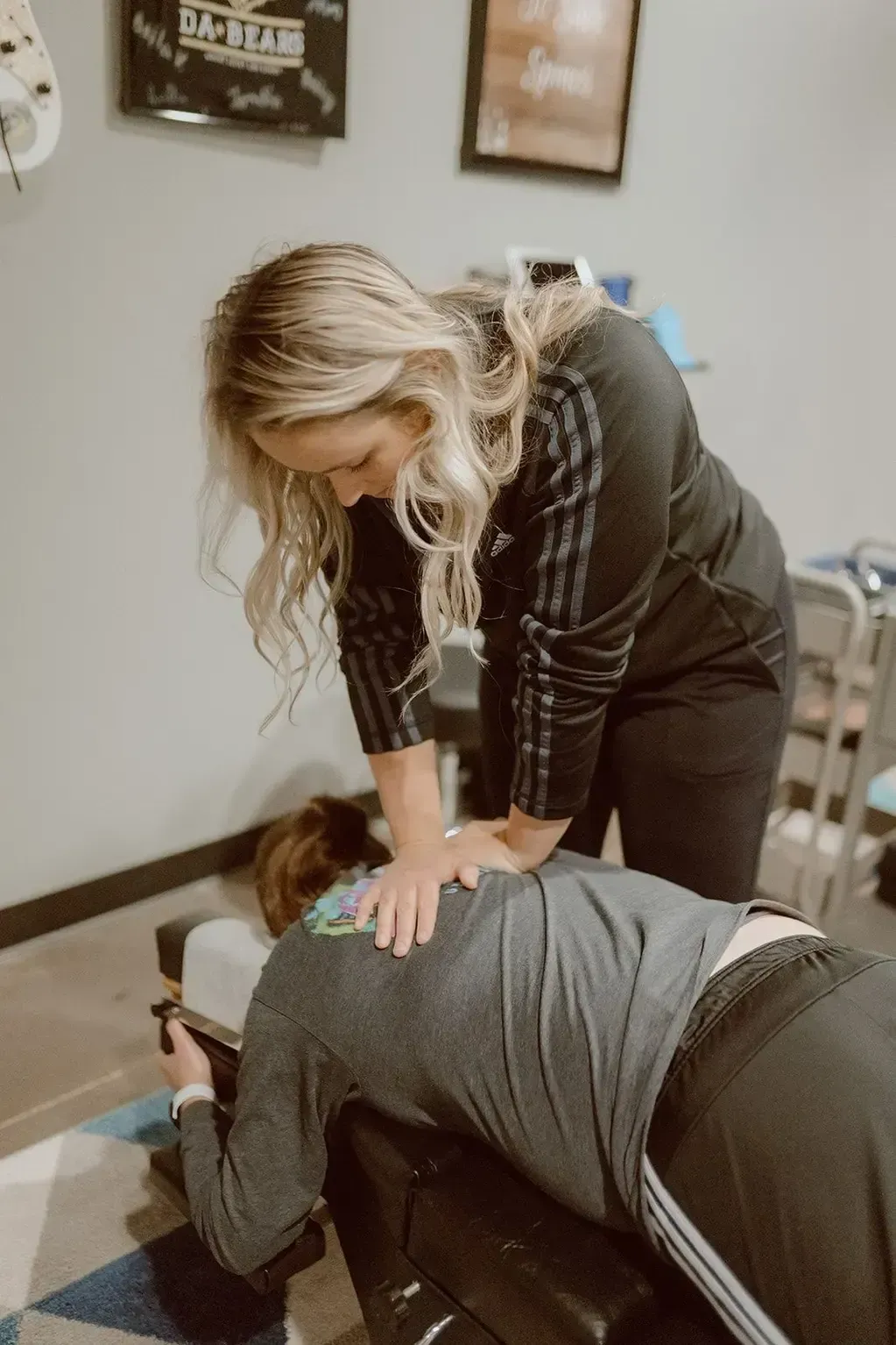 Doctor administering high-precision spinal adjustment on athlete