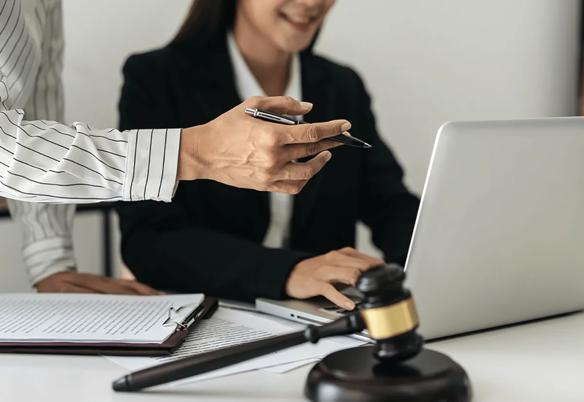 A diverse team of attorneys standing together in a bright, welcoming office, each dressed professionally. The group includes men and women of different ages and backgrounds, all smiling confidently, symbolizing unity and expertise in DUI defense.