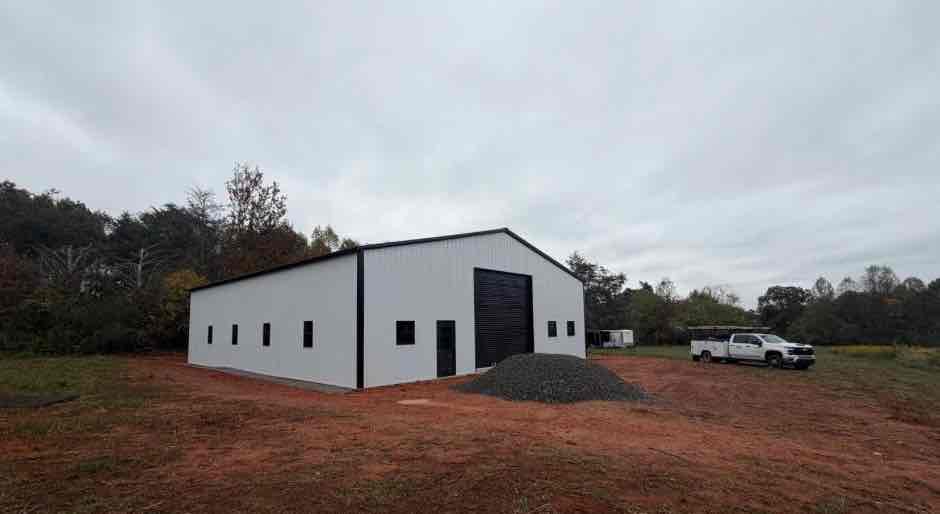 Completed turn-key metal building in North Carolina with 50x60x16 steel structure on a 50x60 concrete slab, grading included by Premier Grading & Concrete.
