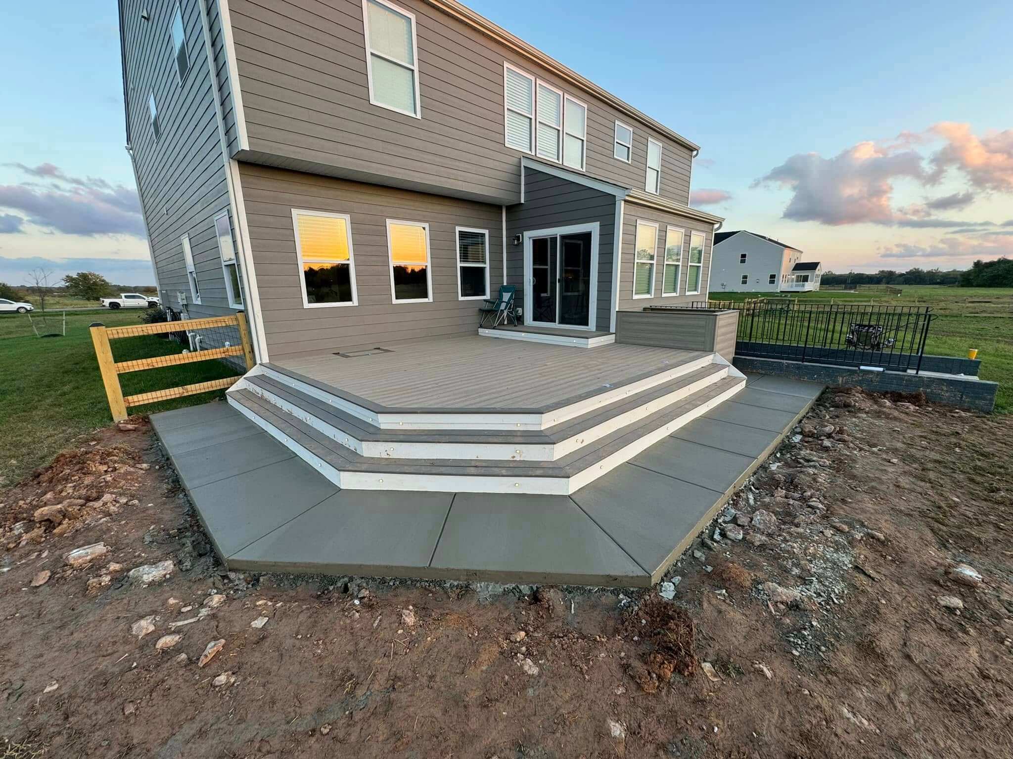 Concrete walkway and monolithic pad installation with notched edge detail at a residential property in North Carolina