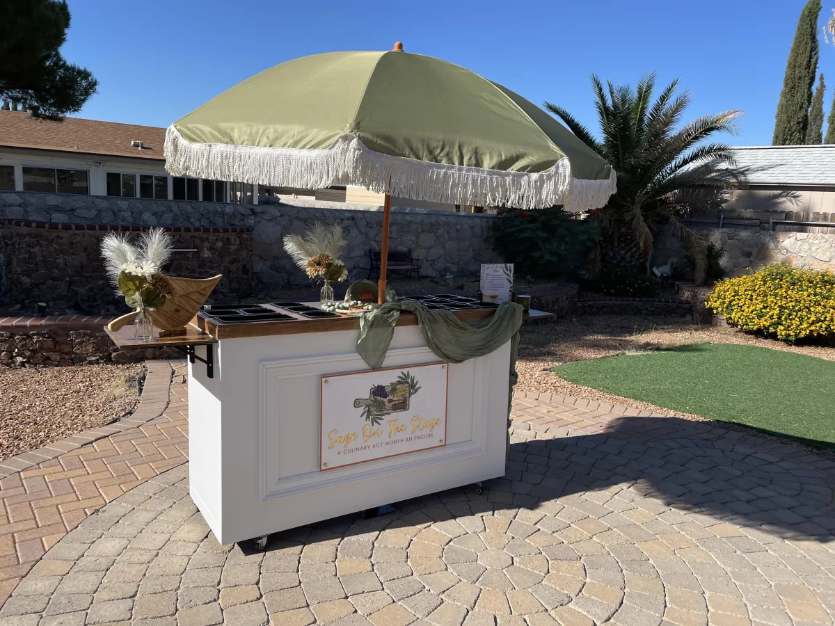 Two diverse founders in aprons arranging charcuterie ingredients in a sunlit kitchen, surrounded by fresh produce and artisan breads, with a warm, inviting atmosphere and a focus on craftsmanship.