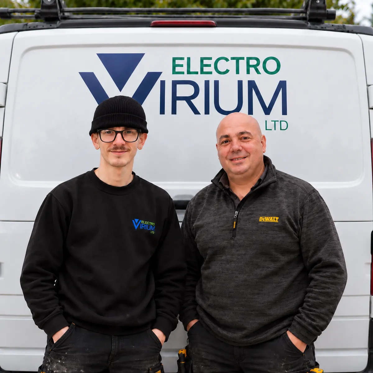 Gary and Max from Electro Virium Ltd, your local electricians in Macclesfield, standing in front of their branded company van