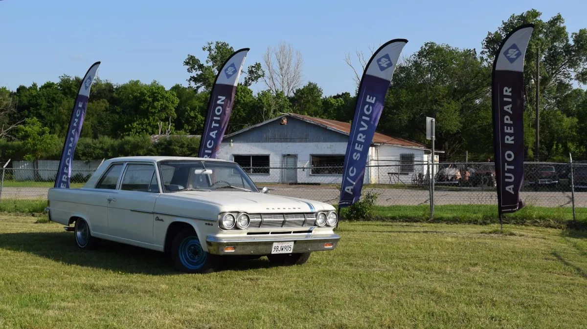 White chevy in front of Straightline automotive mechanic shop