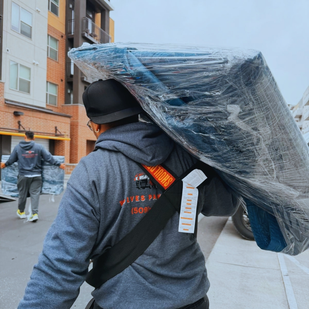 people sitting down near table with assorted laptop computers
