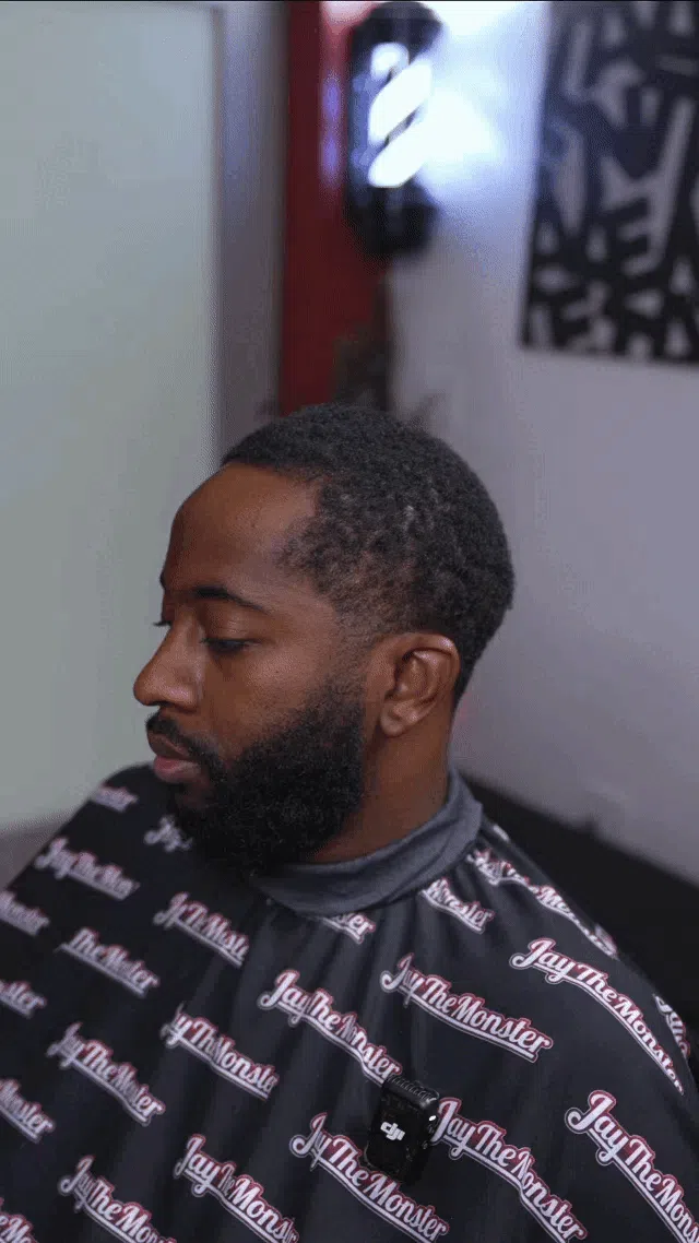 a person cutting a woman's hair with scissors