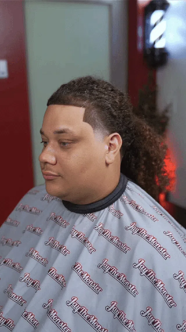 a person cutting a hair