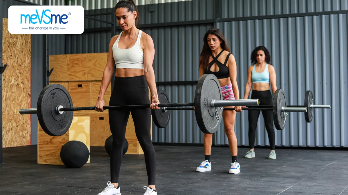 Women strength training together in a supportive fitness studio