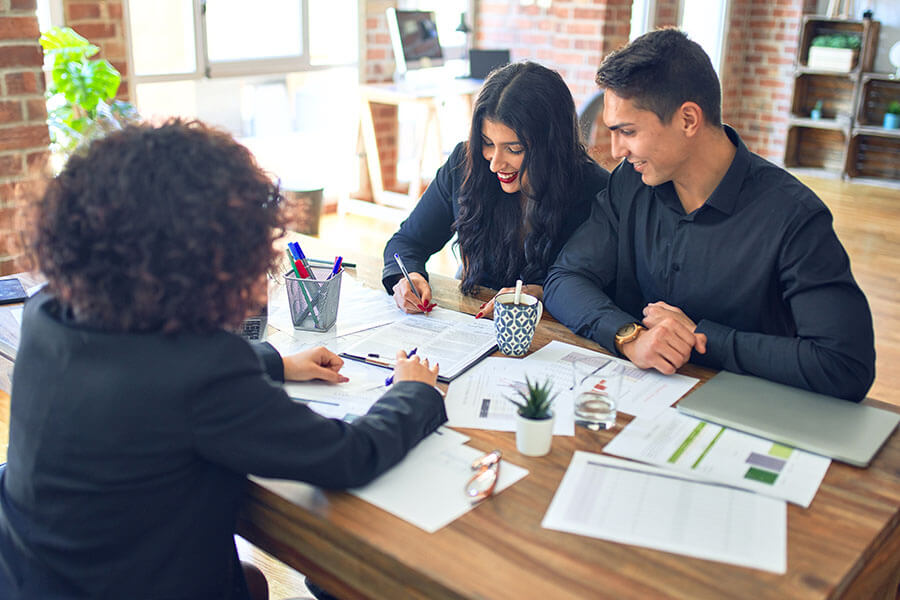 Us dollar bills being inserted into a piggy bank
