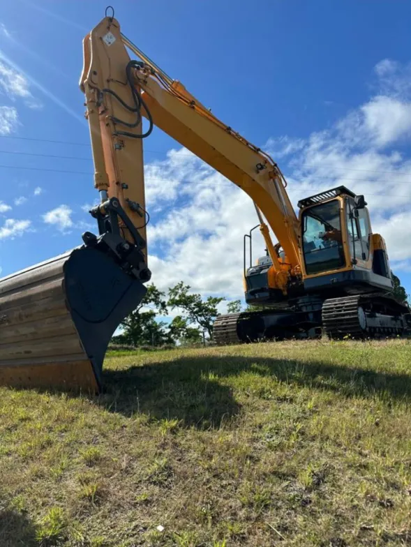 Digger hire service by Dean Moore Excavation, handling earthworks on a Southland property.