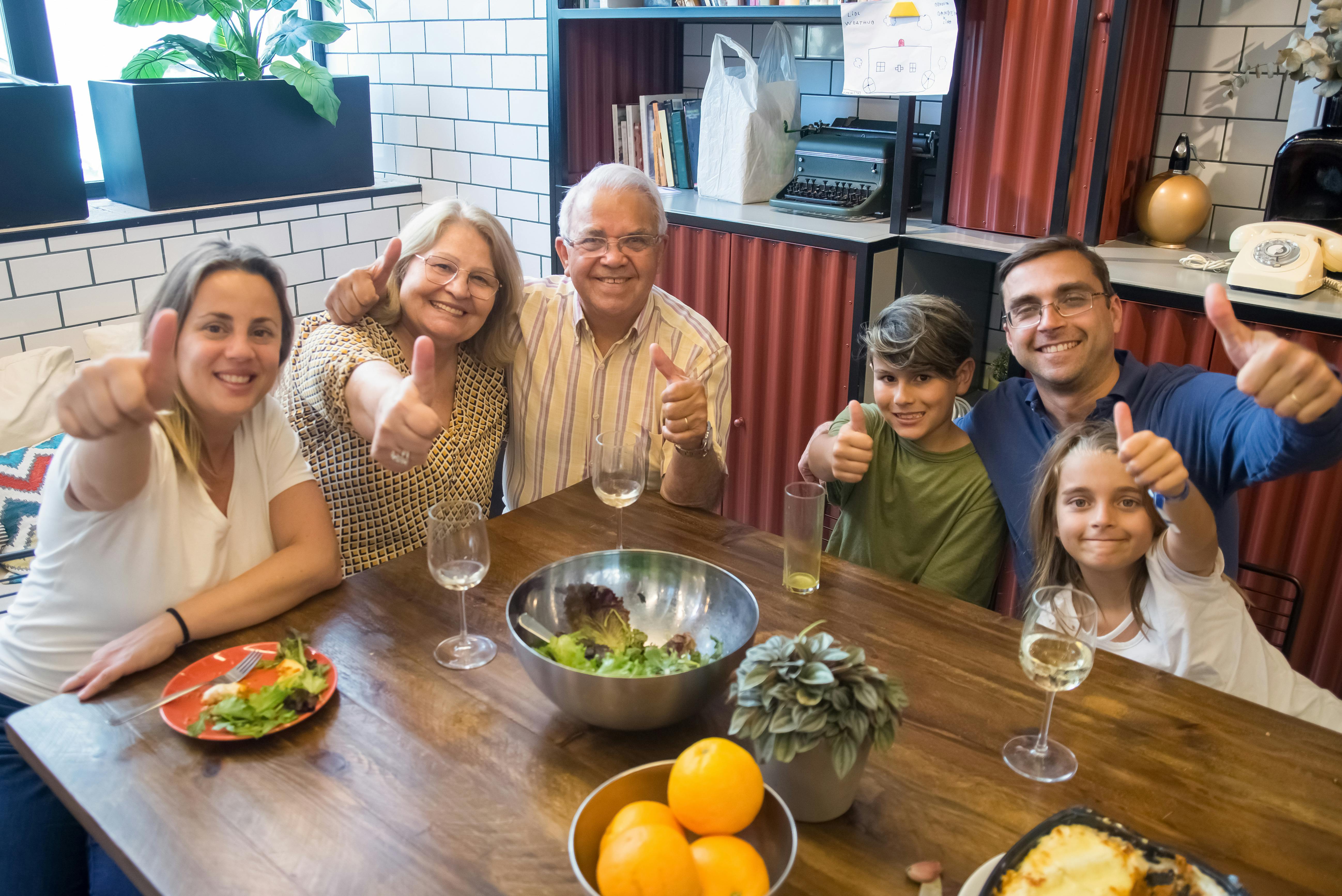 Latin American multigenerational family at home with multiple adults and an elderly parent