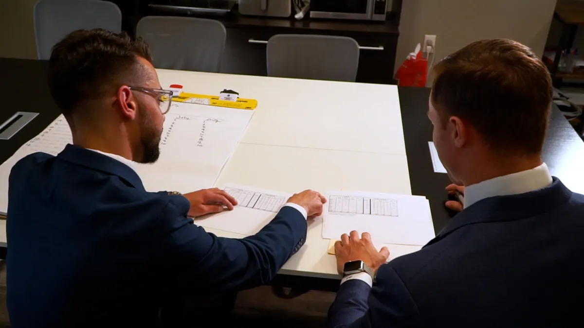 Retail store manager reviewing AI-powered sales dashboard with staff, modern retail environment, diverse team, digital screens displaying sales growth charts, bright and professional setting