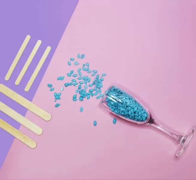 Blue ax Beads spilling out of a champagne glass