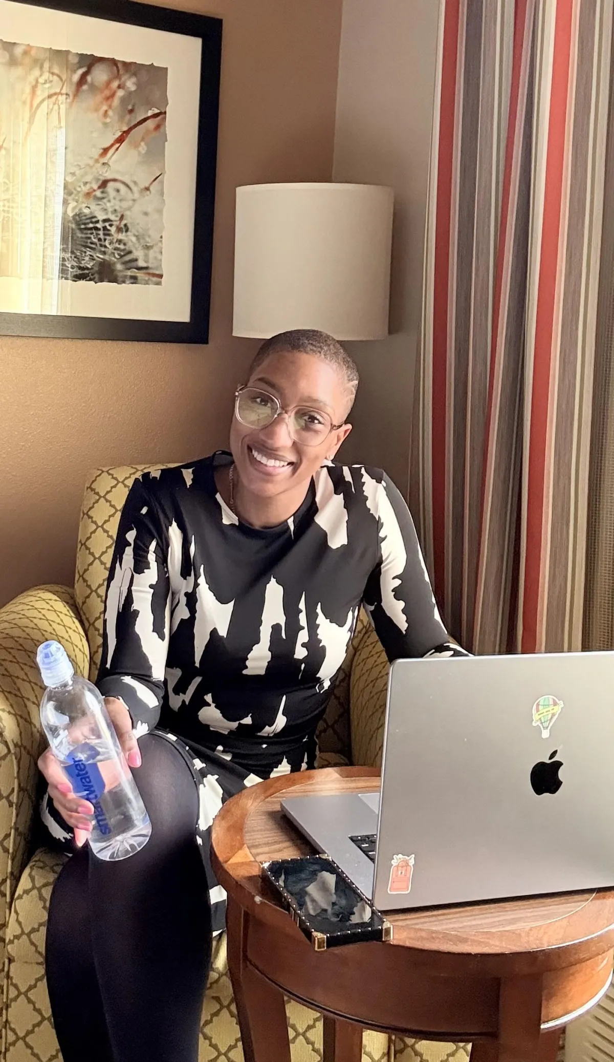 A woman in a hotel behind her computer