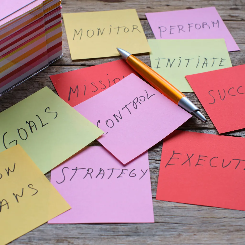 A close-up of a hand lighting a candle beside a journal, pen, and a cup of herbal tea on a wooden table. The scene is tranquil, with soft morning light and a sense of mindful ritual, symbolizing self-care and intention.