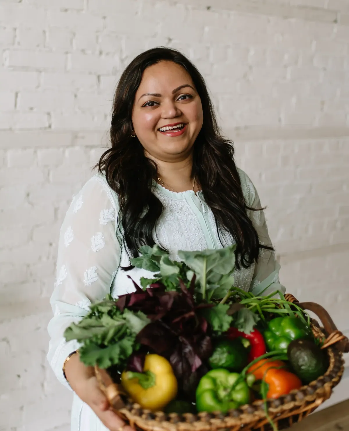 Manjiri has fruit & veggie basket in a hand