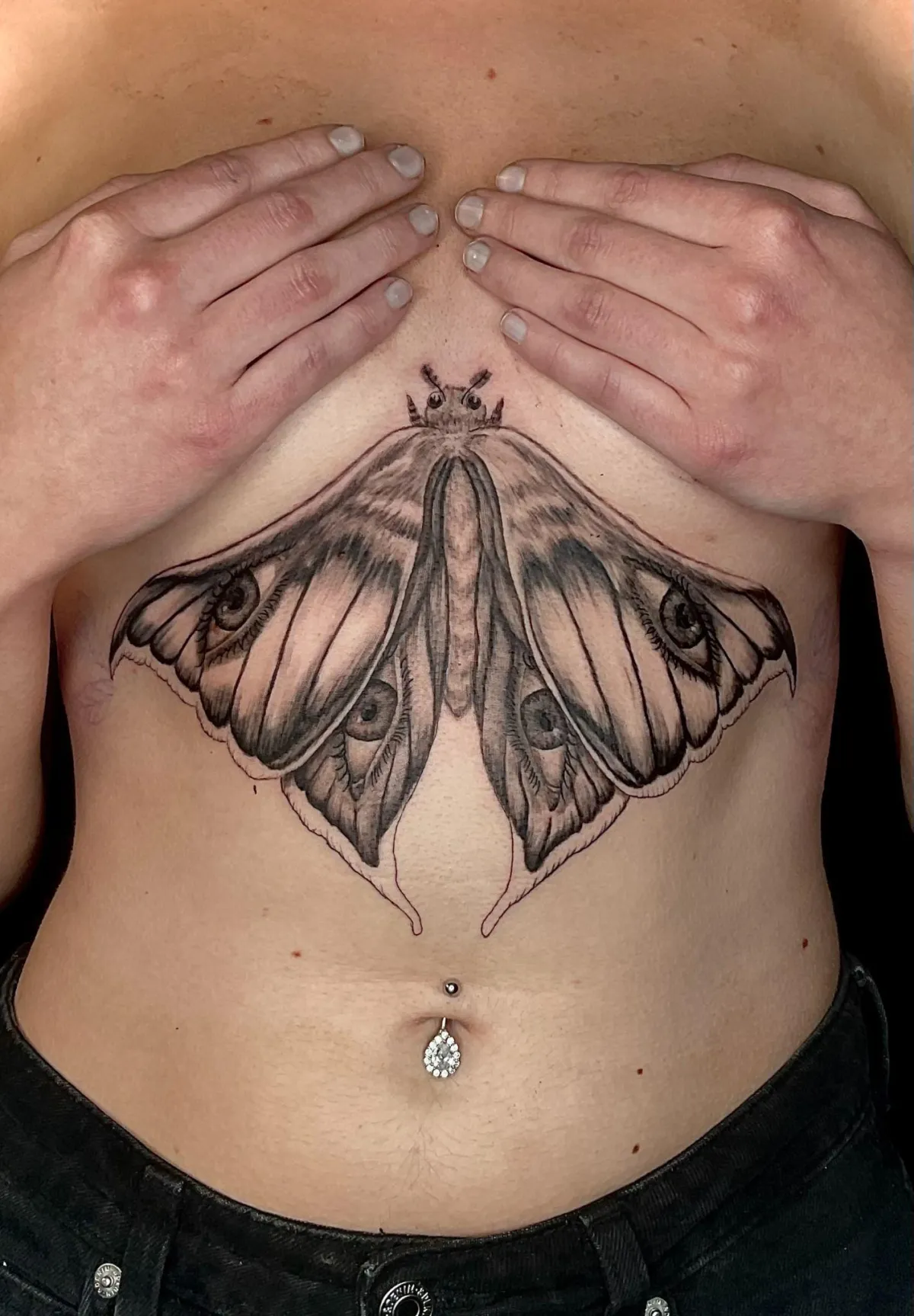 person in blue denim shorts and white nike sneakers standing on gray concrete floor