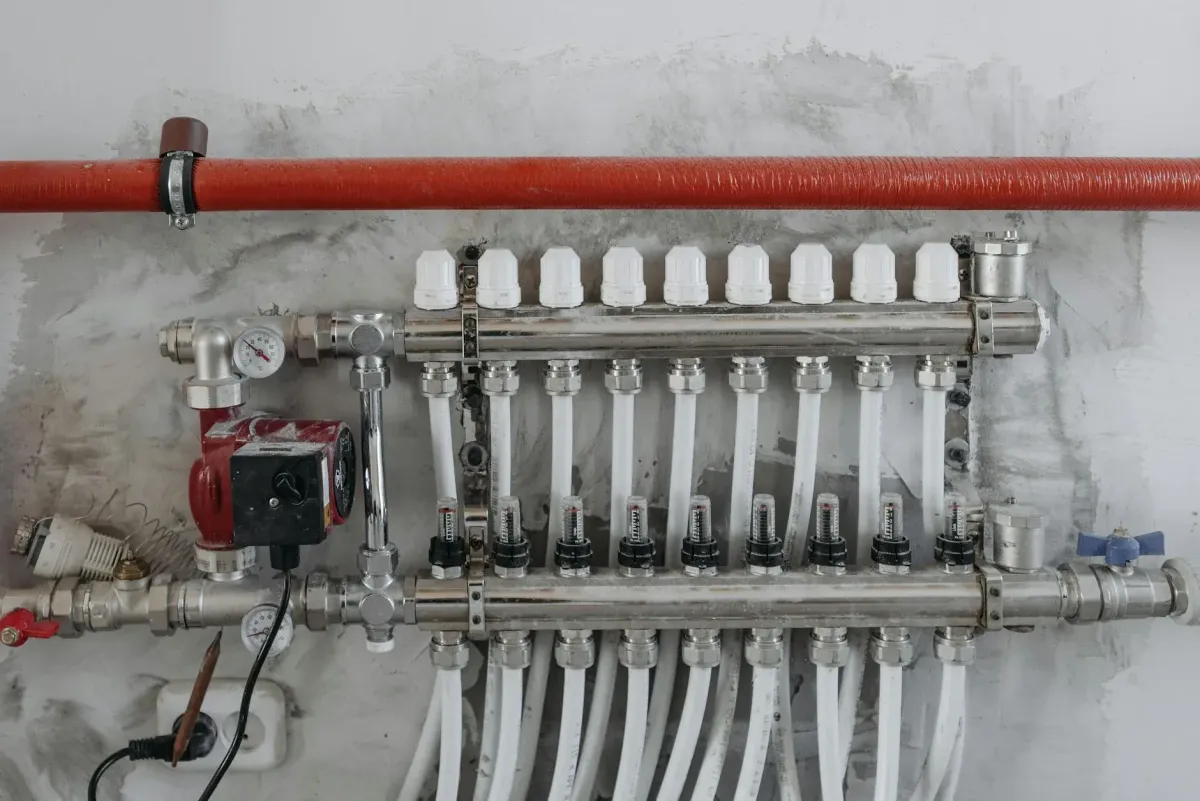 Plumber cutting out a corroded burst pipe section