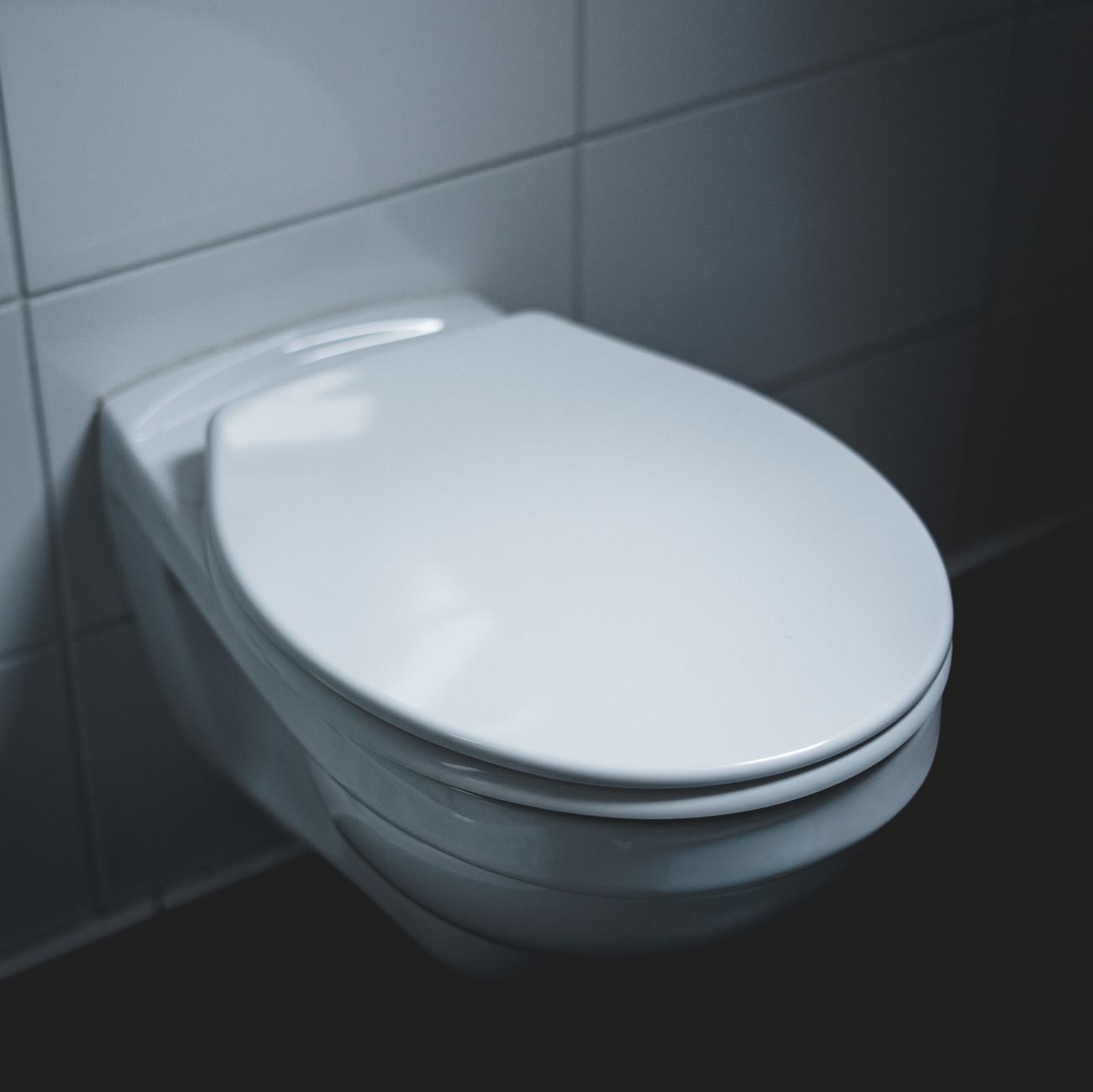 Water pooling around the base of a leaking toilet