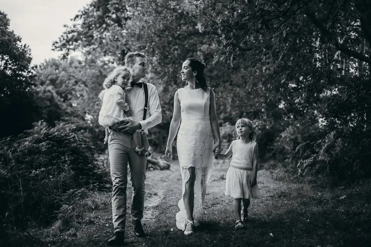 silhouette photo of three person near body of water during sunset