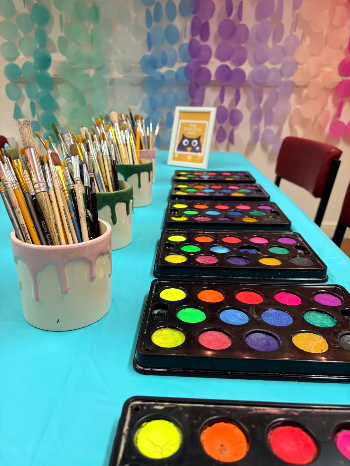 Hull craft studio set up for a paint and sip workshop with easels, canvases, and colourful décor