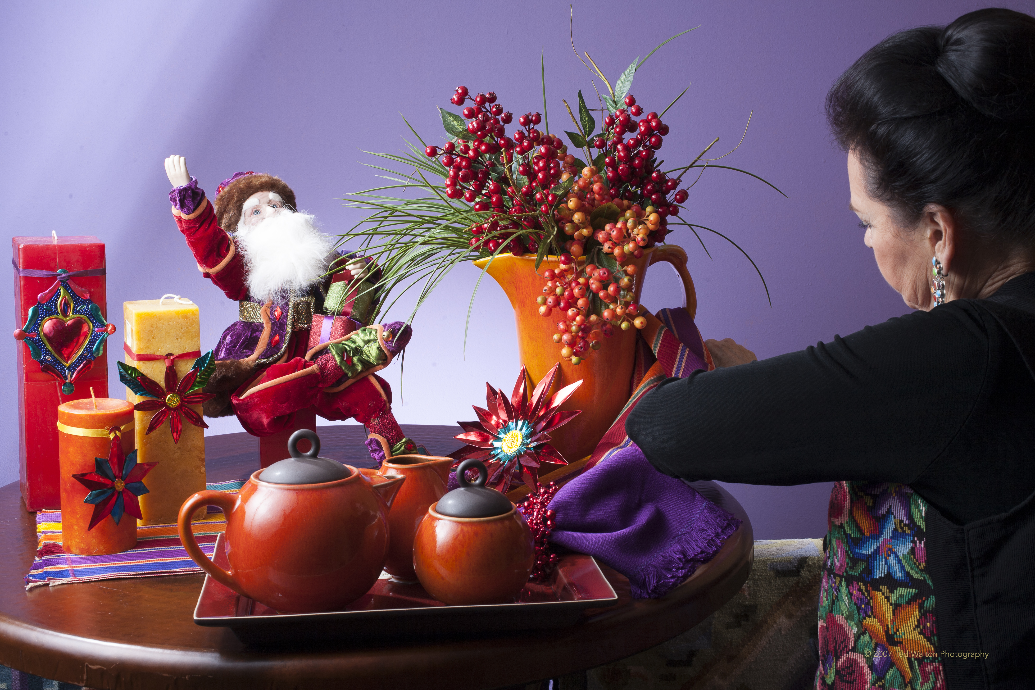 Artisanal Mexican folk art ceramics, Talavera pottery, and hand-carved wooden sculptures in an illuminated niche