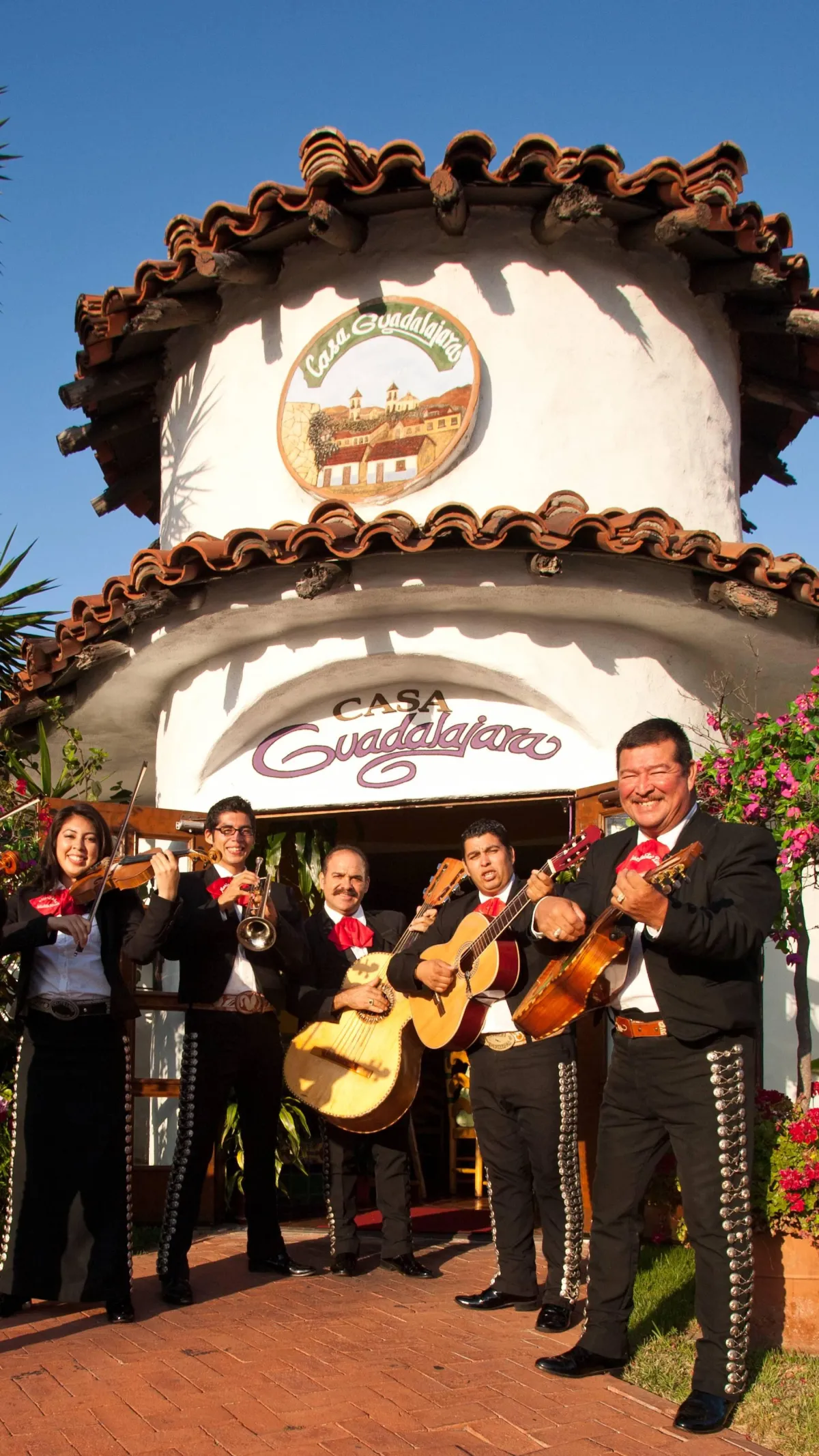 Casa Guadalajara grand hacienda entry with festive paper banners and tile fountain
