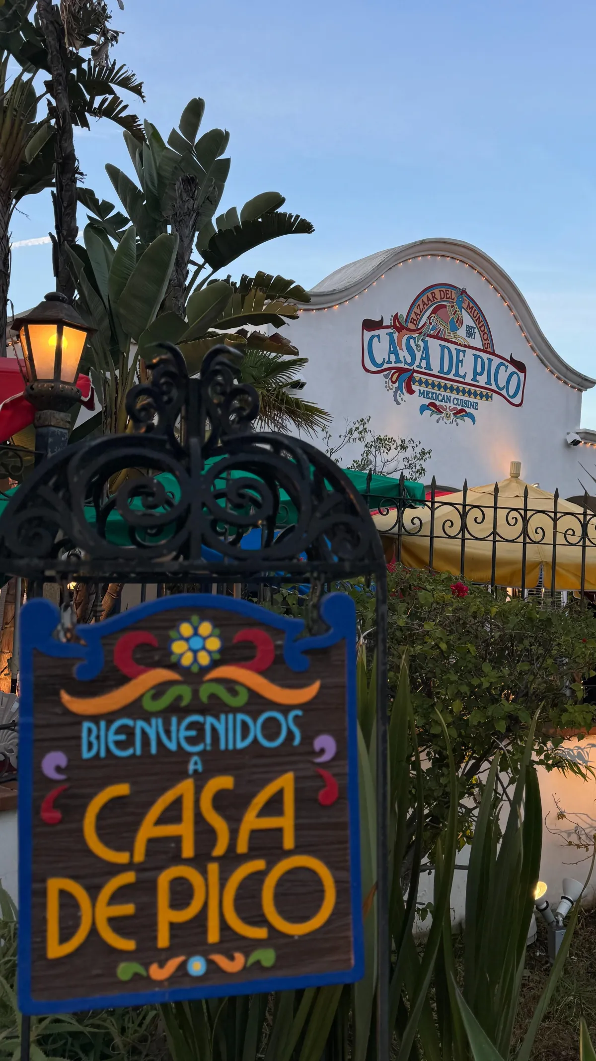Casa de Pico lush fountain courtyard dining with vibrant umbrellas