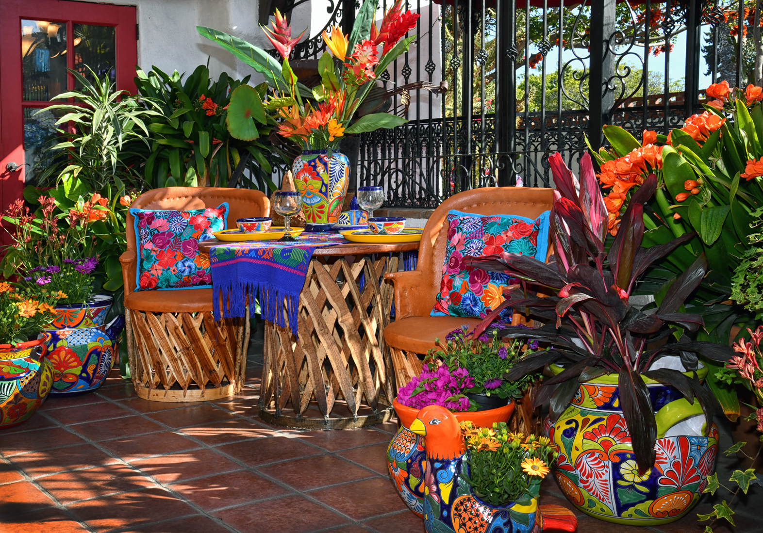 Atmospheric, tactile composition of authentic cobalt blue Talavera tiles layered with fresh vibrant marigold petals and warm Mexican courtyard ceramic textures under natural golden sunlight