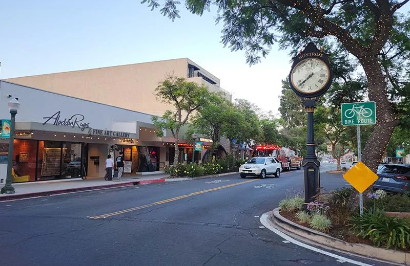 A street view of Montrose, California, with a large clock in the foreground