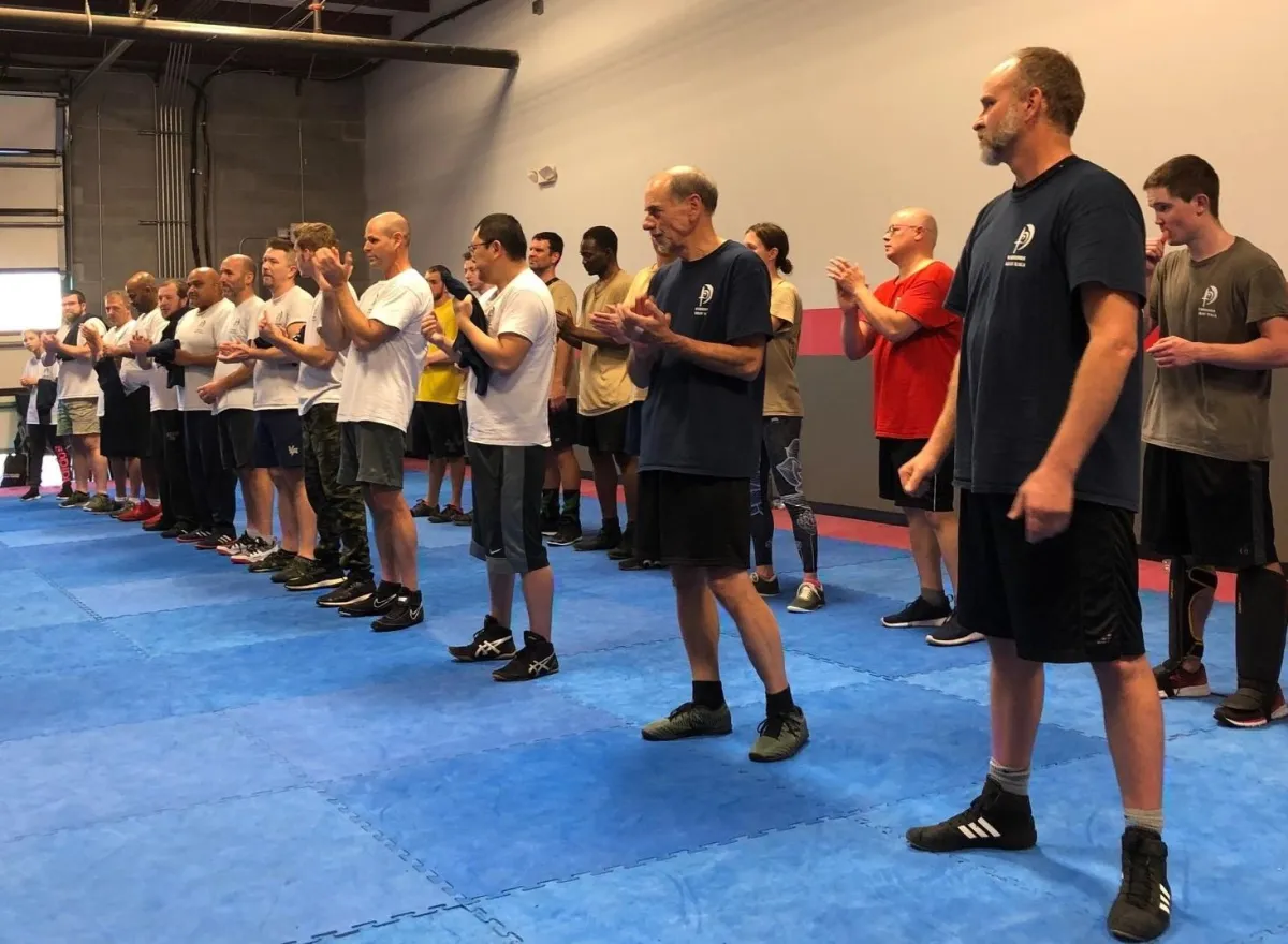 A picture of about 40 adult students lined up at our Krav Maga Lake Norman school for adult self-defense.