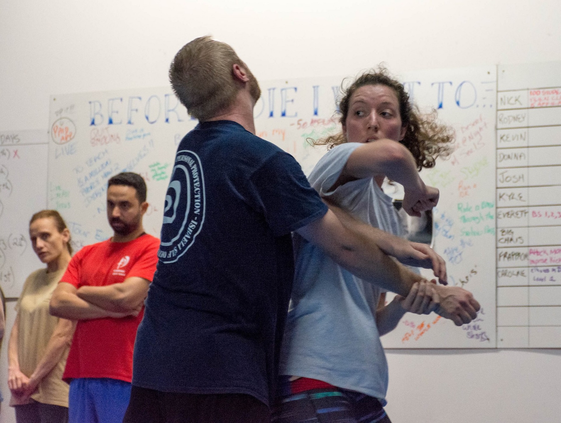 A picture of a teen female student practicing a rear elbow strike