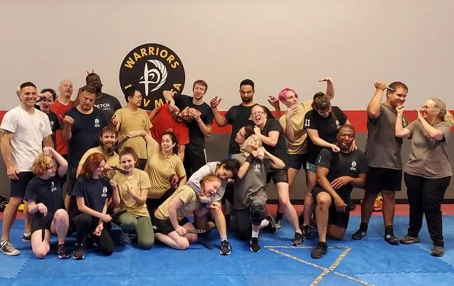 Happy group of students after team-building self-defense class at Krav Maga LKN.