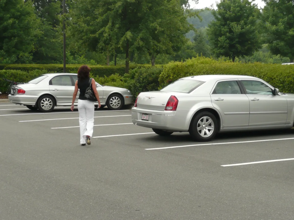 Woman alone in parking lot illustrating dangers of isolation, a key concern in Krav Maga self-defense.