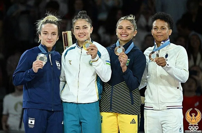 A group of female Judokas after winning at the Olympics.