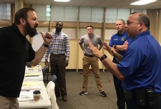 Verbal conflict scene used to highlight real-world de-escalation training in Krav Maga.