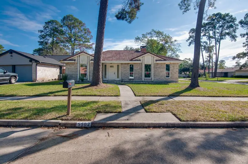Single-story brick home with a front lawn and walkway