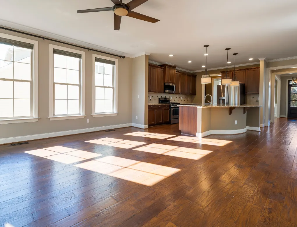 Professional handyman repairing kitchen cabinet in modern white kitchen providing expert home repair and maintenance services for homeowners in North Carolina