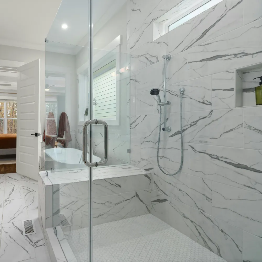 Contemporary kitchen remodel featuring white cabinetry subway tile backsplash granite island and stainless steel appliances for a stylish functional space