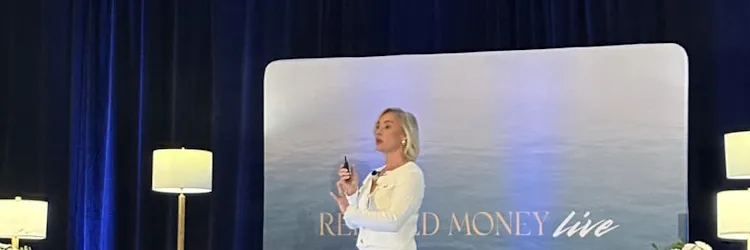 Speaker presenting at the Relaxed Money Live event on stage in front of an audience, discussing money mindset and sustainable wealth.