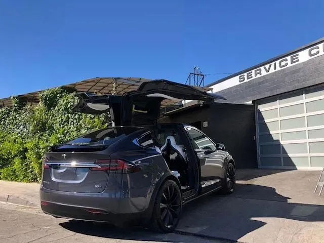 woman placing sticky notes on wall